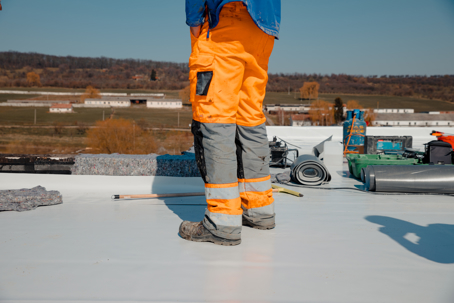 person standing on a white flat roof