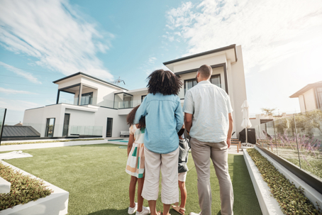 family looking at their home