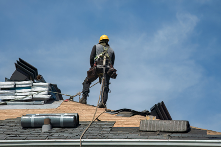 a roof installer standing on a roof